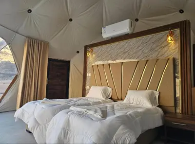 a bedroom with two beds in a tent at Qais Camp Wadi Rum in Wadi Rum