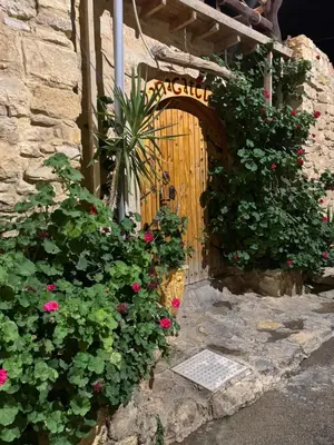 an entrance to a house with a wooden gate and flowers at Dana Gate Lodge in Dana