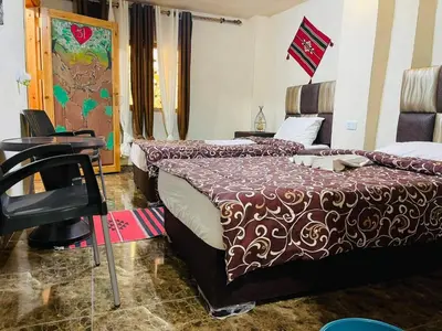 a hotel room with two beds and a desk at Dana Gate Lodge in Dana