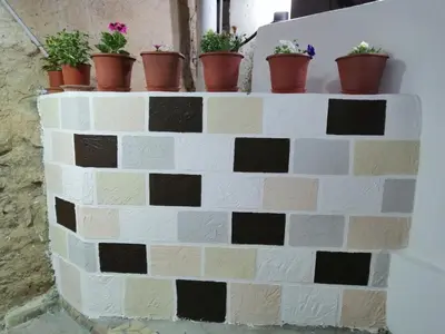a brick wall with potted plants on it at Petra Heritage House in Wadi Musa