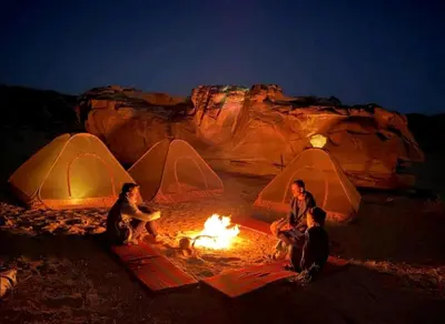 a group of people sitting around a camp fire at Wadi rum Local guide camp in Wadi Rum