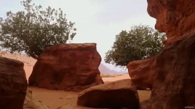 a view of two large rocks in the desert at Sunrise camp in Wadi Rum