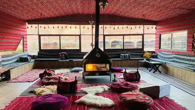 a large room with a fireplace in the middle at Wadi Rum Pyramids Camp in Wadi Rum