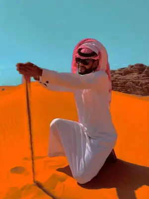 a man in the desert with a rope at Wadi Rum Pyramids Camp in Wadi Rum