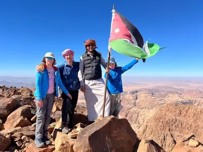 a group of people standing on top of a mountain at Wadi Rum Pyramids Camp in Wadi Rum