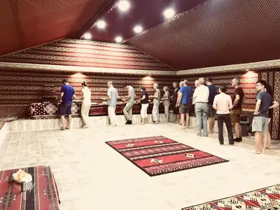 a group of people standing in a room at Wadi Rum Pyramids Camp in Wadi Rum