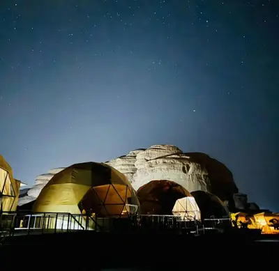 a group of domes at night under a starry sky at Omar Ghazi Camp in Wadi Rum