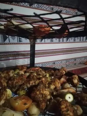 a bunch of food is cooking on a grill at Omar Ghazi Camp in Wadi Rum