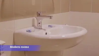 a white sink in a bathroom with the words modern rooms at Al-Mujeb in Kerak