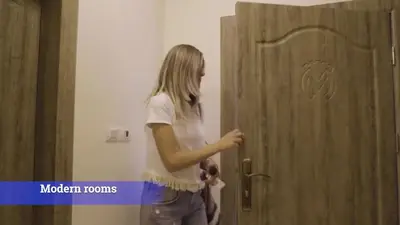 a woman opening a door in a room at Al-Mujeb in Kerak