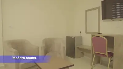 a room with chairs and a table and a tv at Al-Mujeb in Kerak