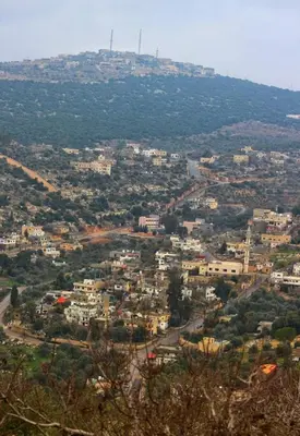 a view of a city with a hill in the background at Mhna guest house بيت الضيافة الريفي in Ajloun