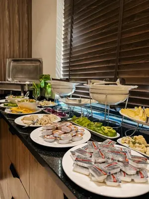 a buffet with many plates of food on a counter at Celino Hotel in Amman