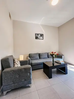 a living room with a couch and a coffee table at Celino Hotel in Amman