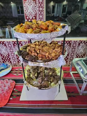 a three tiered display of food on a table at Desert guide camp in Wadi Rum