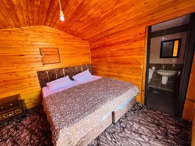 a bedroom with a bed and a sink in a room at wadi rum bedouin stars camp in Wadi Rum