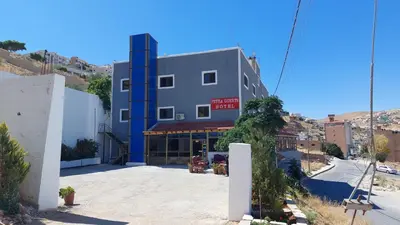 a building on the side of a street at Petra Guests Hotel in Wadi Musa