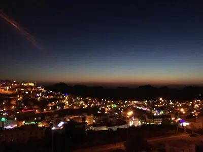 a view of a city lit up at night at Petra Guests Hotel in Wadi Musa