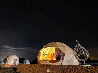 a group of domes under a starry sky at Rum Jordan camp and tours in Wadi Rum