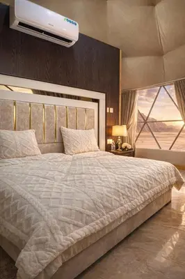 a bedroom with a large bed with a ceiling at Rum Jordan camp and tours in Wadi Rum