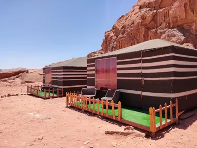 a group of buildings sitting in the desert at Wadi Rum Desert Base Camp in Wadi Rum