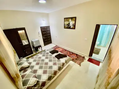 a bedroom with a bed in the middle of the room at Petra View Flat in Wadi Musa