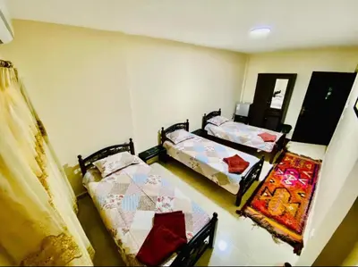 two twin beds in a room with at Petra View Flat in Wadi Musa