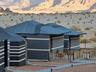a building with a blue roof in the desert at Beduin Star Trail Camp in Wadi Rum