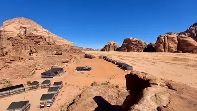 a view of the desert with rocks in the background at Beduin Star Trail Camp in Wadi Rum