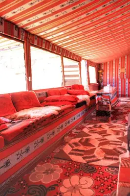 a living room with a long couch in a room at Beduin Star Trail Camp in Wadi Rum