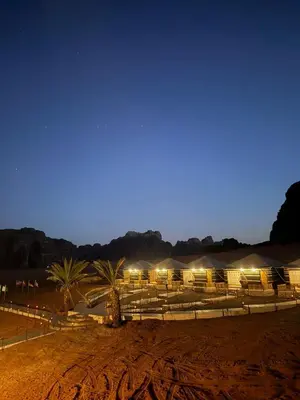 a group of chairs in a field at night at Khazali Mountain Camp in Wadi Rum
