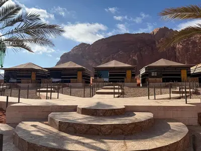 a group of buildings with a mountain in the background at Khazali Mountain Camp in Wadi Rum