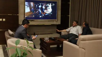 a group of people sitting in a living room with a tv at Big Ben Hotel Suites in Amman