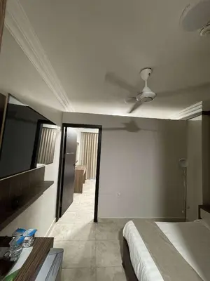 a bedroom with a bed and a ceiling fan at mass paradise2 in Aqaba