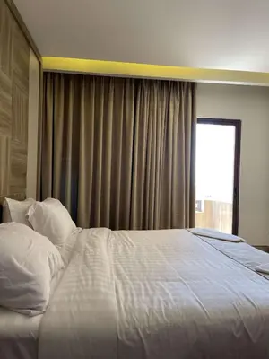 a large white bed in a bedroom with a window at mass paradise2 in Aqaba