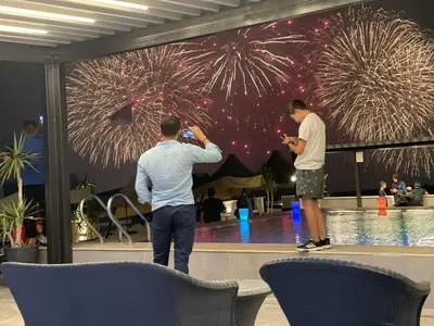 two men taking pictures of fireworks at a party at mass paradise2 in Aqaba