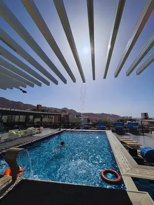 a swimming pool with a view of the mountains at mass paradise2 in Aqaba