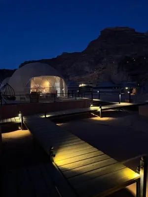 a view of a building with lights at night at Taj Wadi Rum camp in Wadi Rum