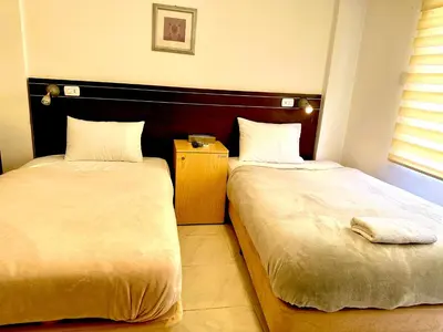 two beds sitting next to each other in a room at Petra Town Check-Inn in Wadi Musa