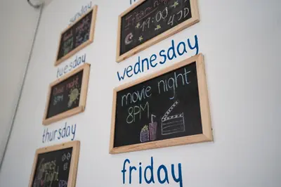 a group of chalkboards on a wall with writing on them at Battuta Hostel in Amman