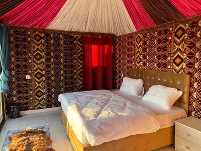a bedroom with a bed in a tent at Wadi Rum Desert Adventures in Wadi Rum