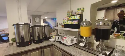 a kitchen with a counter with a bunch of blenders at Layaali Amman Hotel in Amman