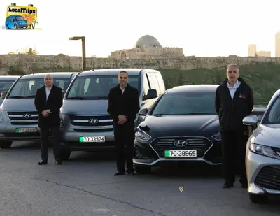 a group of men in suits standing in front of cars at Layaali Amman Hotel in Amman