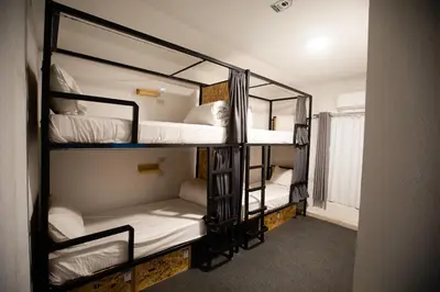 a room with three bunk beds in a room at Nomads Hotel in Wadi Musa
