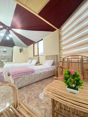 a bedroom with a bed and a table and chairs at مخيم الجبال البرونزية in Wadi Rum