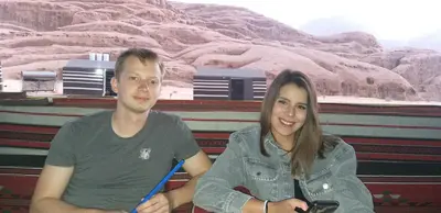a man and a woman sitting next to each other at مخيم الجبال البرونزية in Wadi Rum