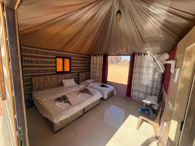 a bedroom with two beds in a tent at Myra Stars Camp & Tours in Wadi Rum