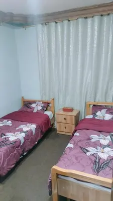 two beds sitting next to each other in a room at Wateen Home in Wadi Musa
