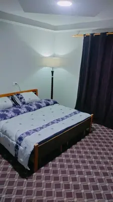 a bedroom with a bed and a lamp in it at Wateen Home in Wadi Musa