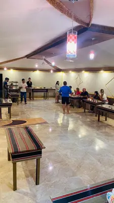 a group of people in a room with ping pong tables at Traditions of Wadi Rum camp & jeep tour in Wadi Rum